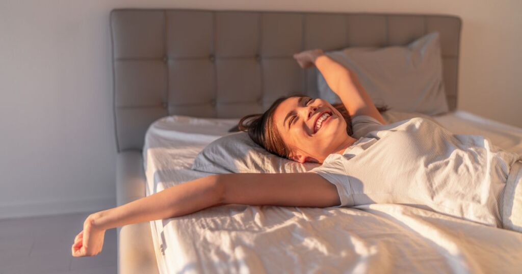happy woman sleeping on mattress